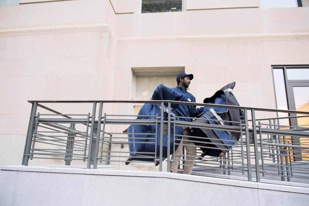Carrying office chairs out of building