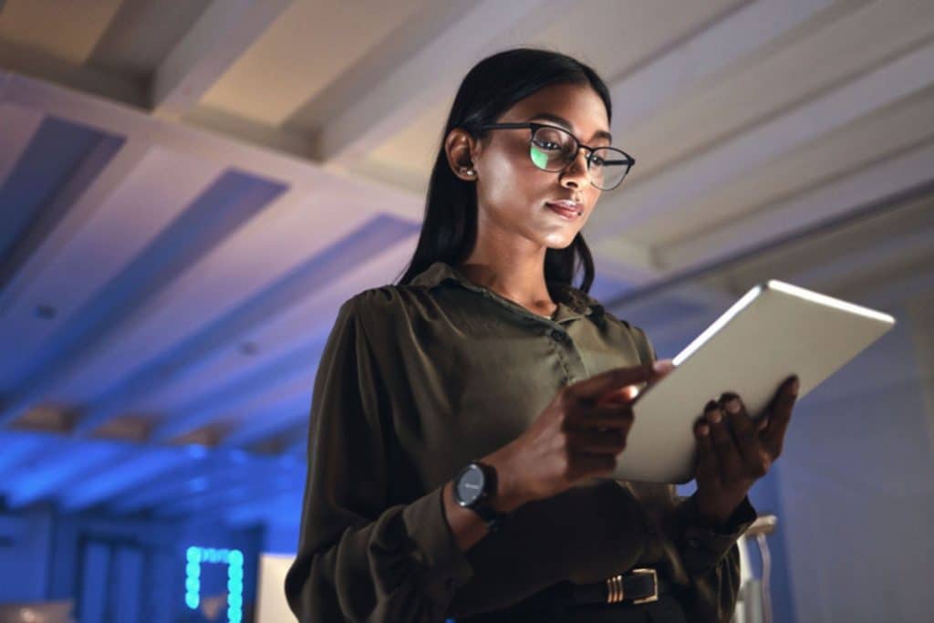 Business woman reading tablet istock